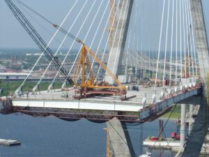 A stiff leg derrick is used on a bridge construction project.