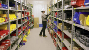 An AMECO tool crib attendant scans out a tool for distribution on a jobsite.